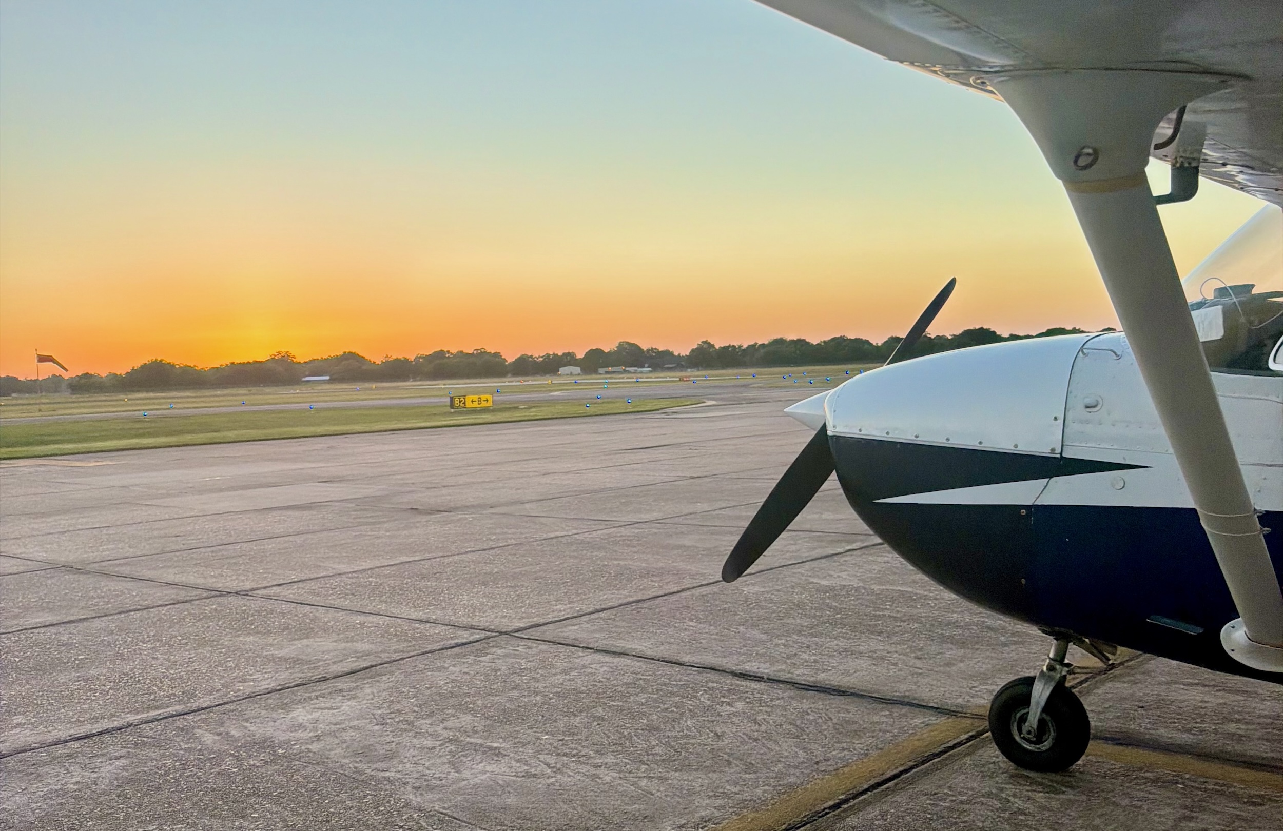 Photo of the nose of a Cessna 172 on the ramp at sunset